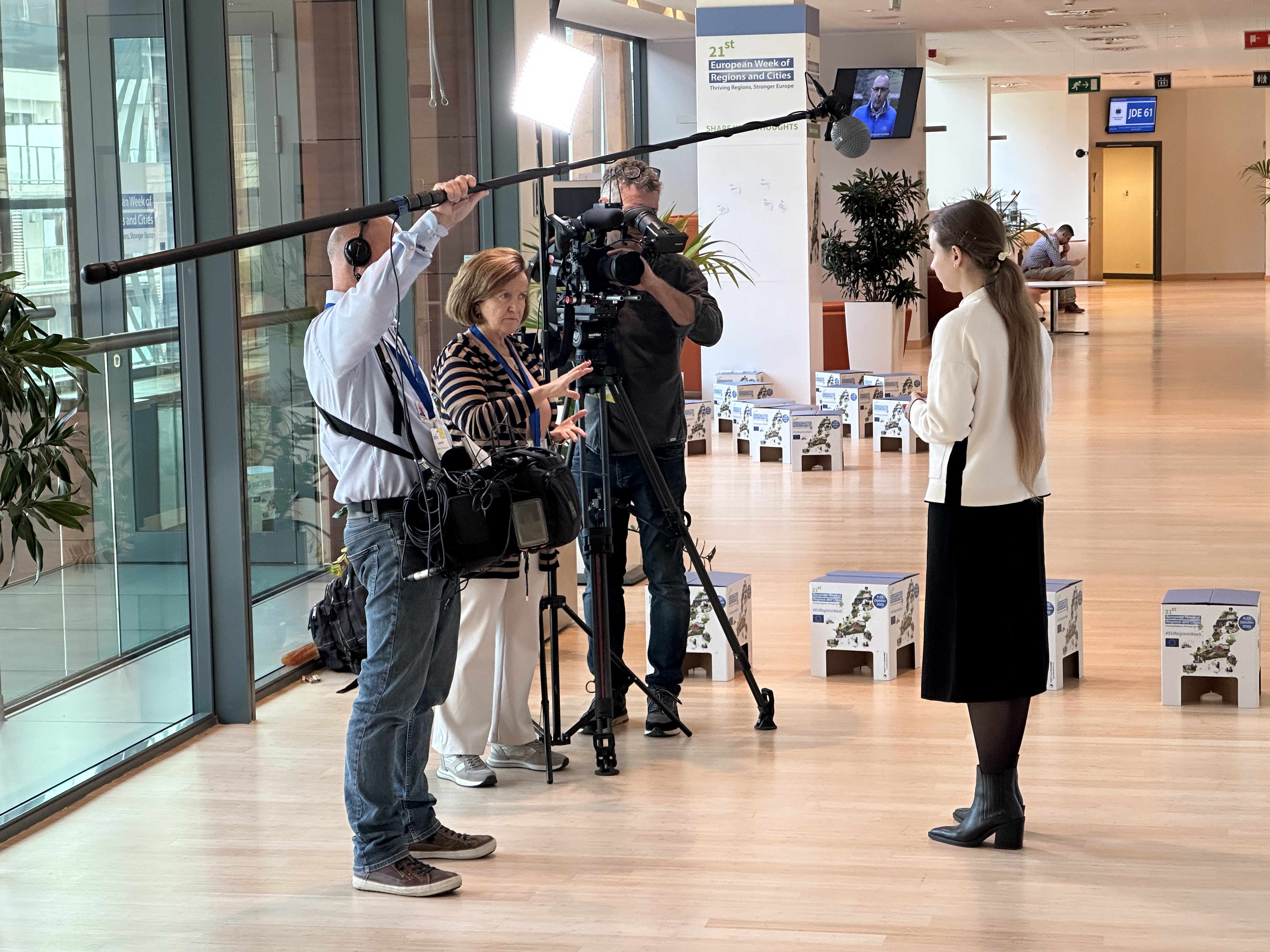 Fullscreen Productions crew filming an interview at the 21st European Week of Regions and Cities